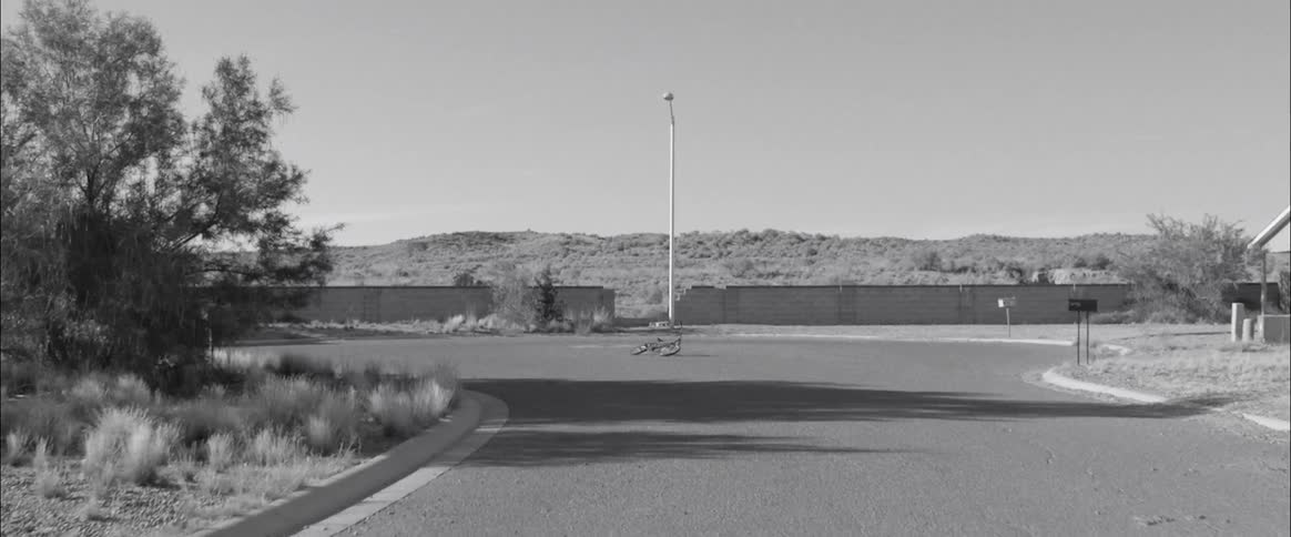 A bike lies in the middle of a cul de sac