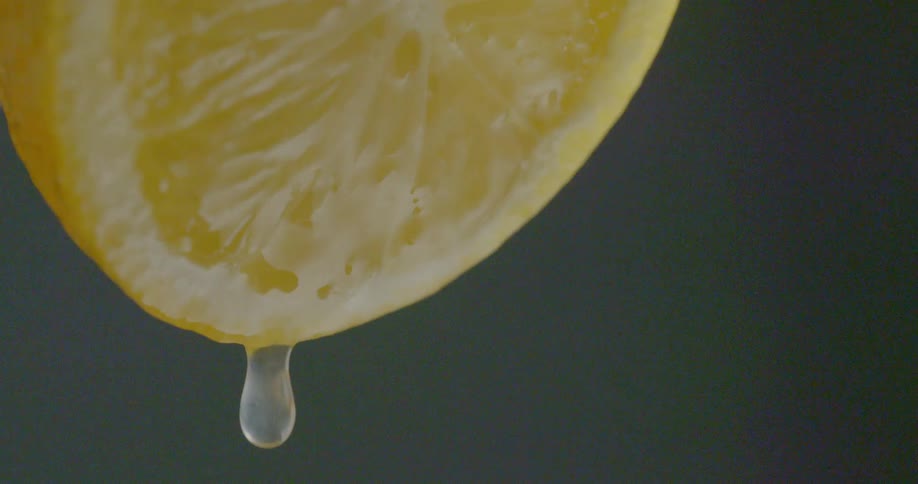 Juice drips from a cut lemon
