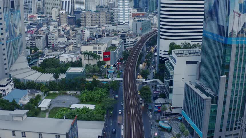 A city with buildings roads and train tracks
