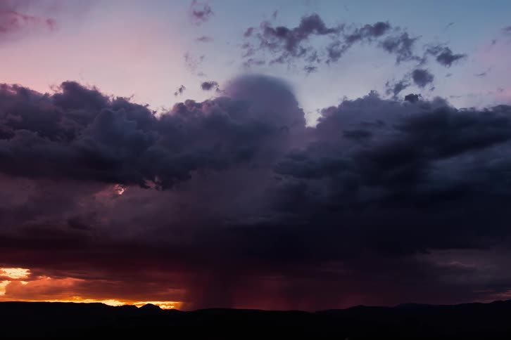 The storm clouds move over the horizon at dawn