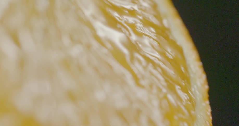Juice drips down sliced orange half