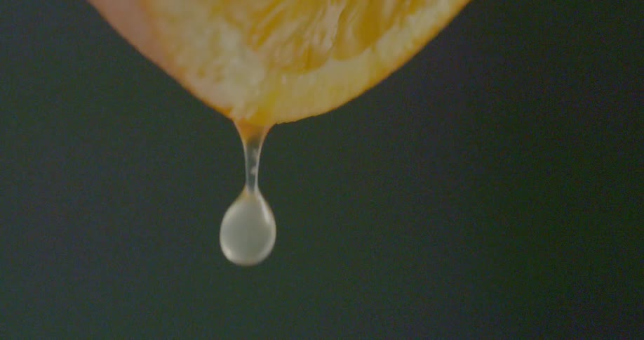 Juice drips from sliced orange