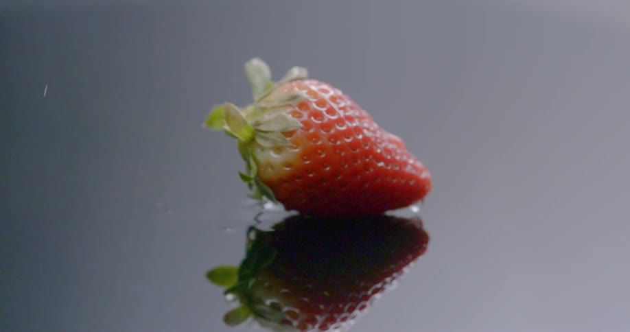 A strawberry falls on the counter
