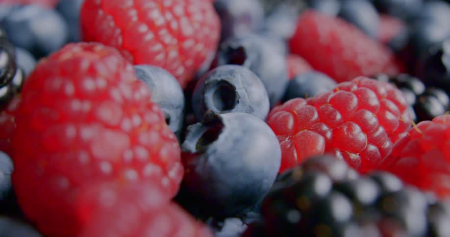 Raspberries blackberries and blueberries in a pile
