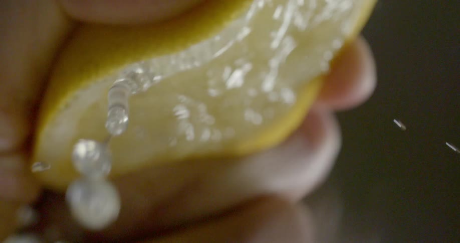 A person squeeze a lemon until juice comes out