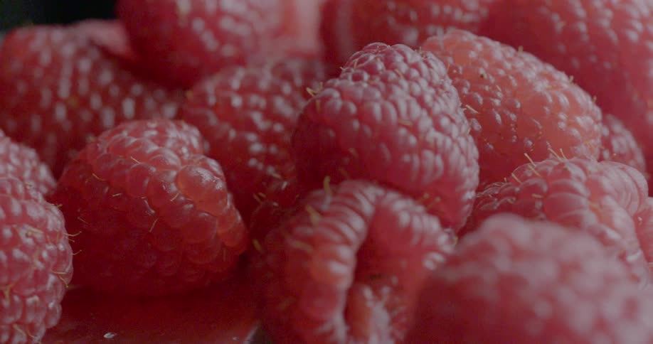 Close up of fresh ripe raspberries clustered together