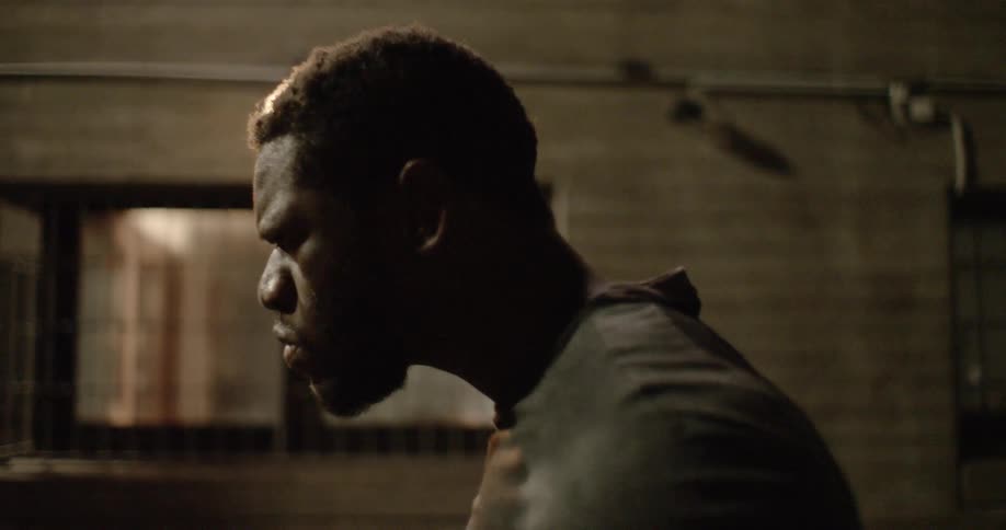 A man stands up and runs in the dark room