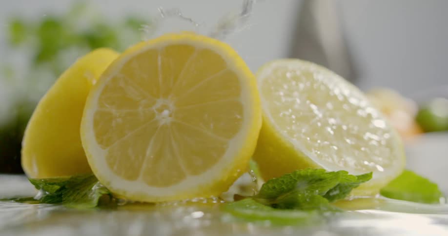 Lemon halves spin around as water drips on them