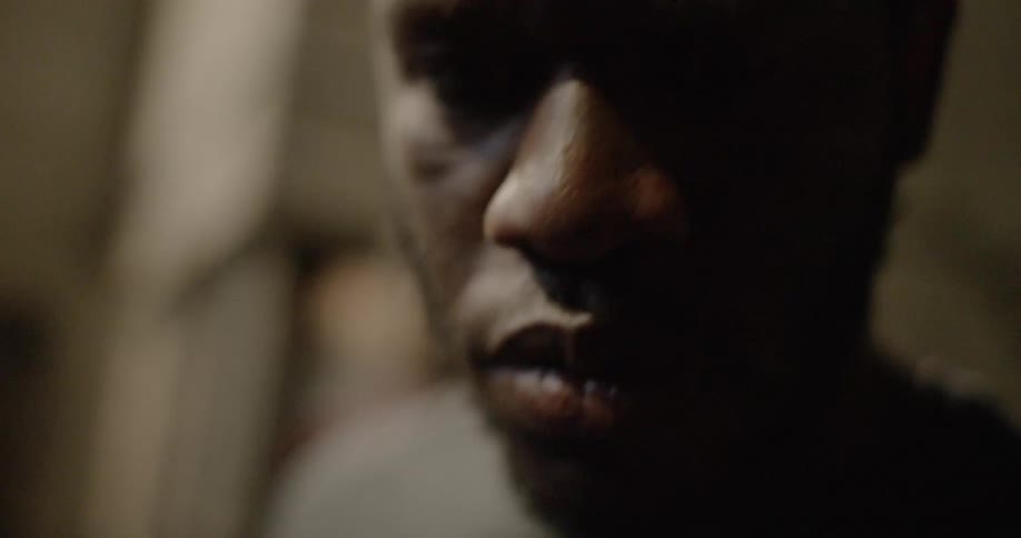 A man is looking forward in the dark