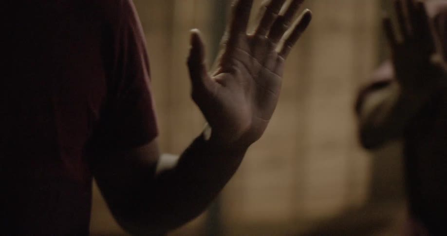 A person makes gestures and holds their hands up