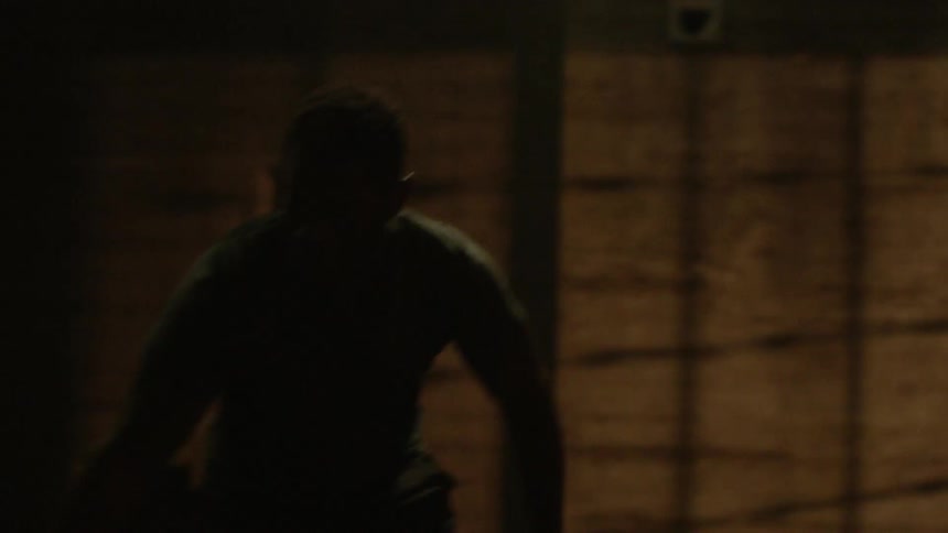Group of men playing basketball inside a building at night