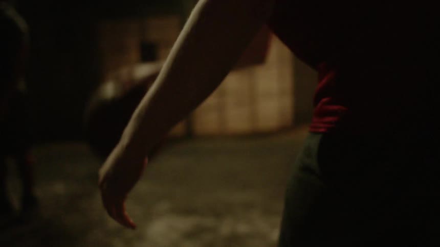 A teenager bounces a basketball