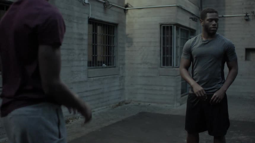 Two black men pass a basketball around