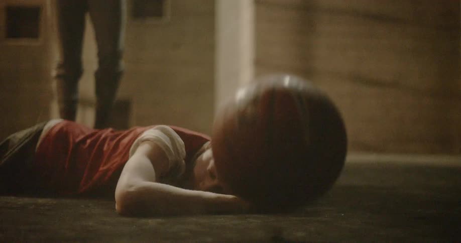 A man falls on the ground during a basketball game
