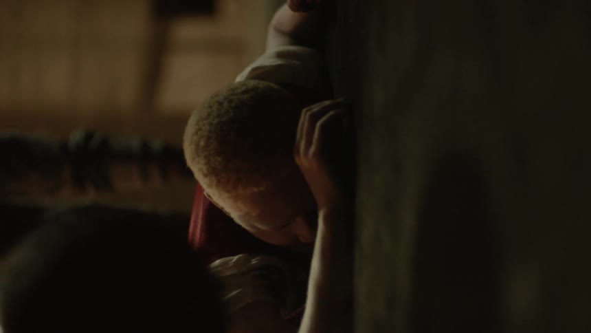 A male teenager is pushed to the ground and a basketball is thrown at him