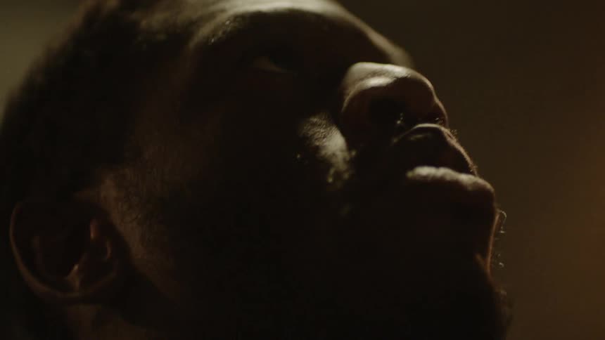 Black male moves his arms in an upward direction