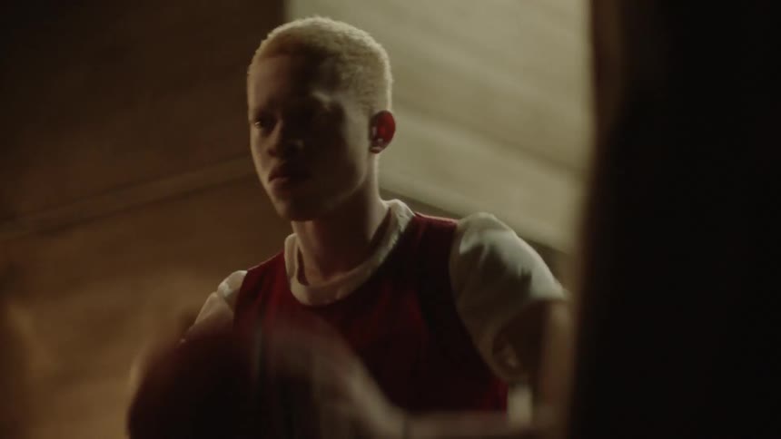 A teenager passes a basketball