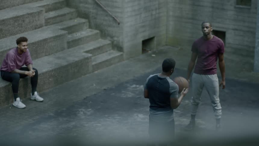 Group of friends play with basketball inside building