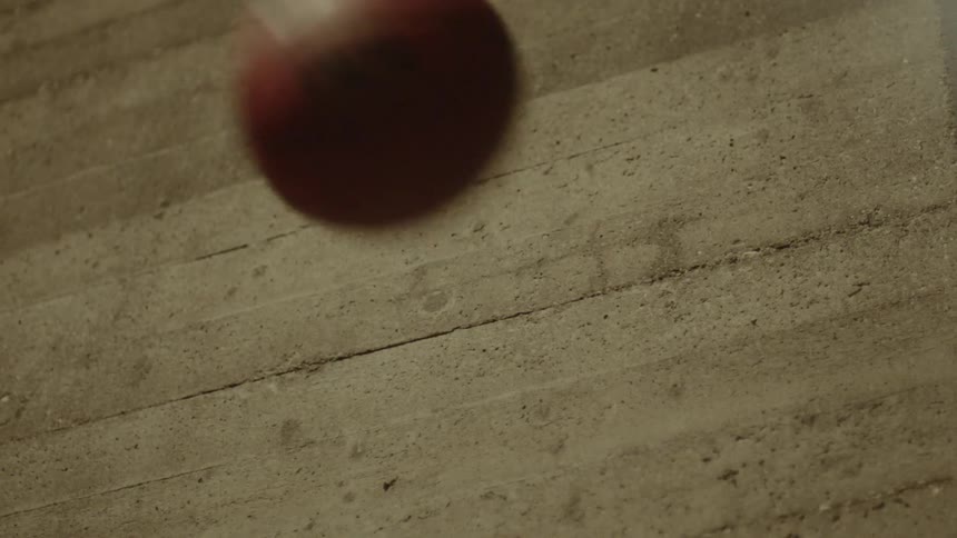 A ball bounces on a concrete wall
