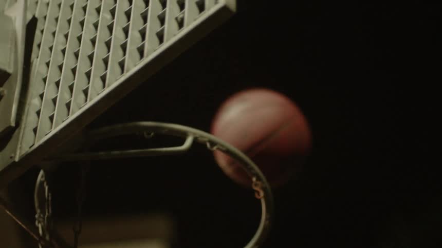 A basketball misses the hoop