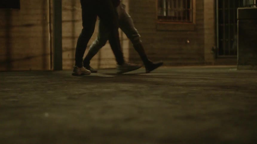 A group of teenagers run around on a court together