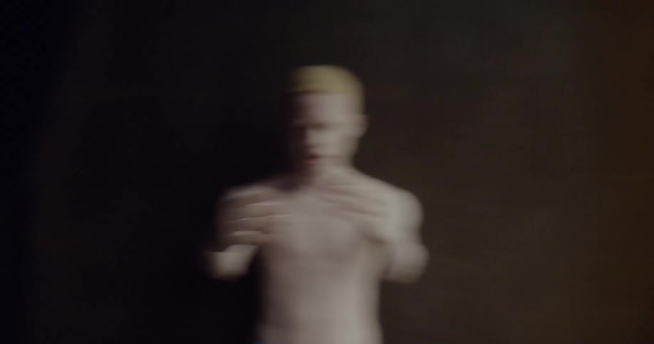 A man raises his hands in front of his face