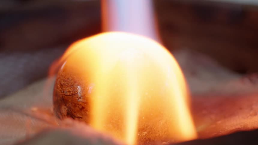 A torch is being used on a glass sphere