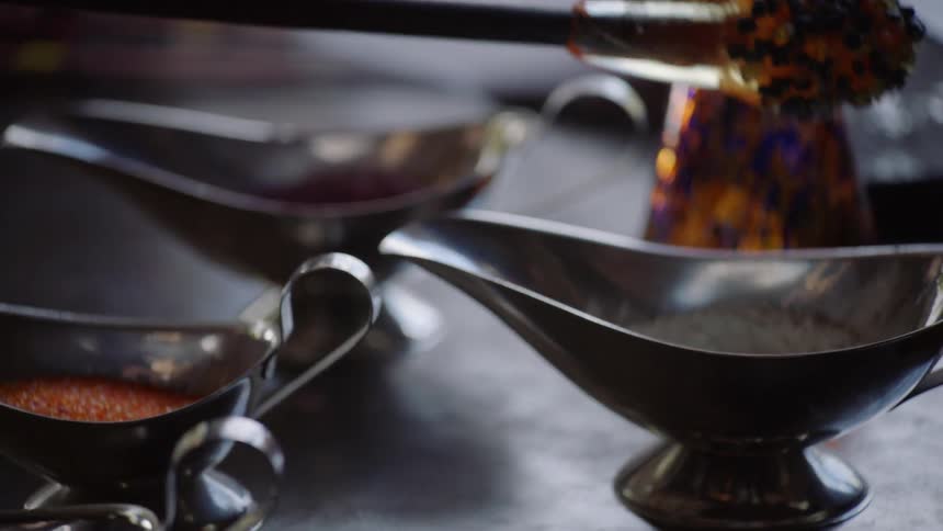 Hot glass for glass blowing is dipped in powder