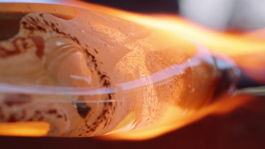 Glass on pole is rotated in fire