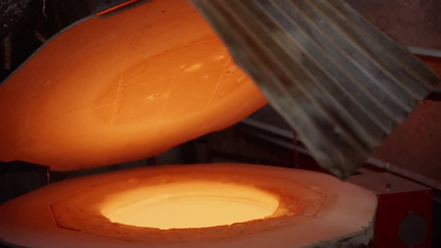 Glass is dipped in to heat to get ready for glass blowing