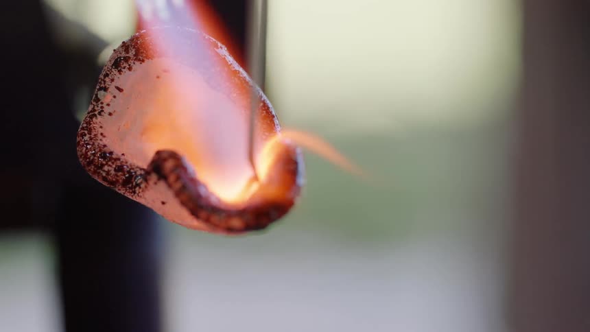 Torch flame is applied to metal chain