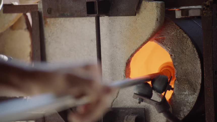 A person is glass blowing