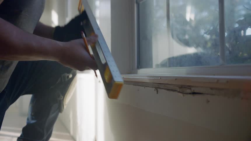 A man levels a window