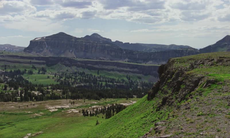 The hills are covered with green on a cloudy day
