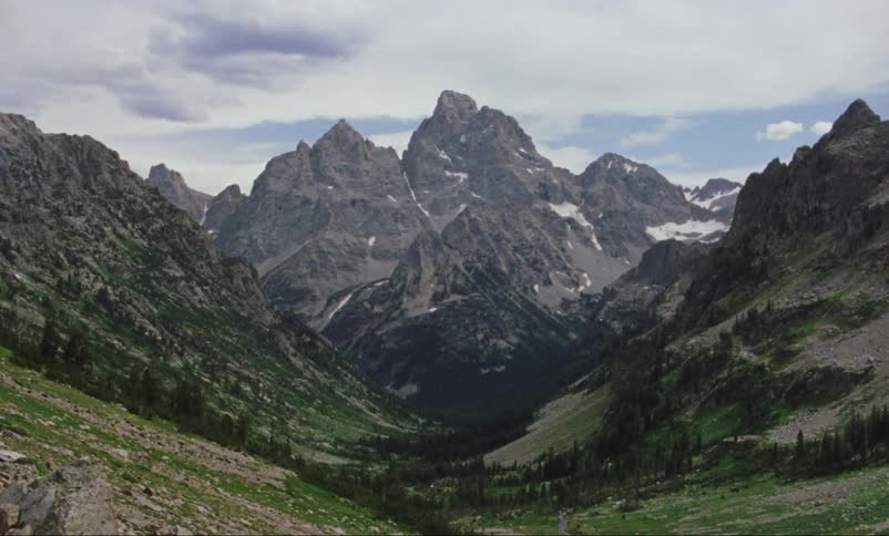 Vintage footage of rocky mountain range and valley