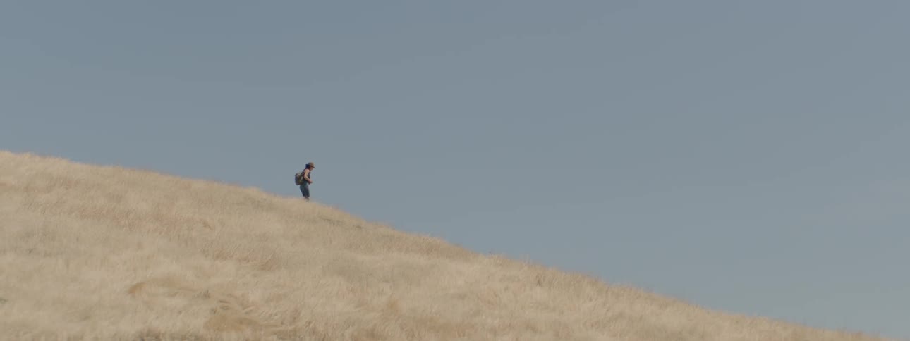 A person hikes down the hill