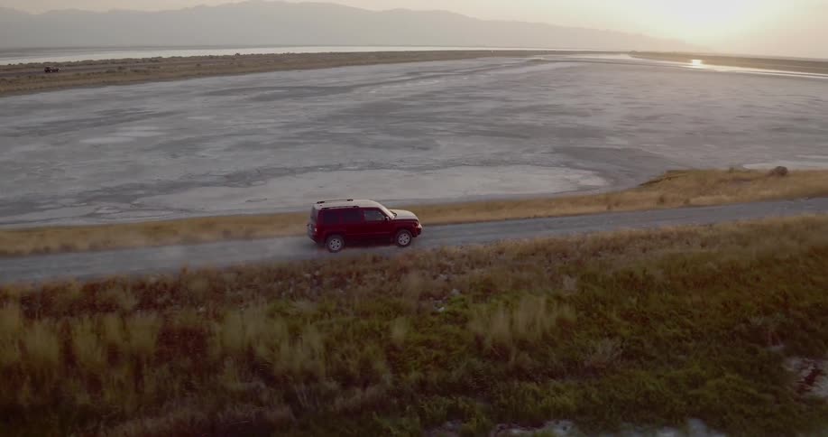 A vehicle drives along a road