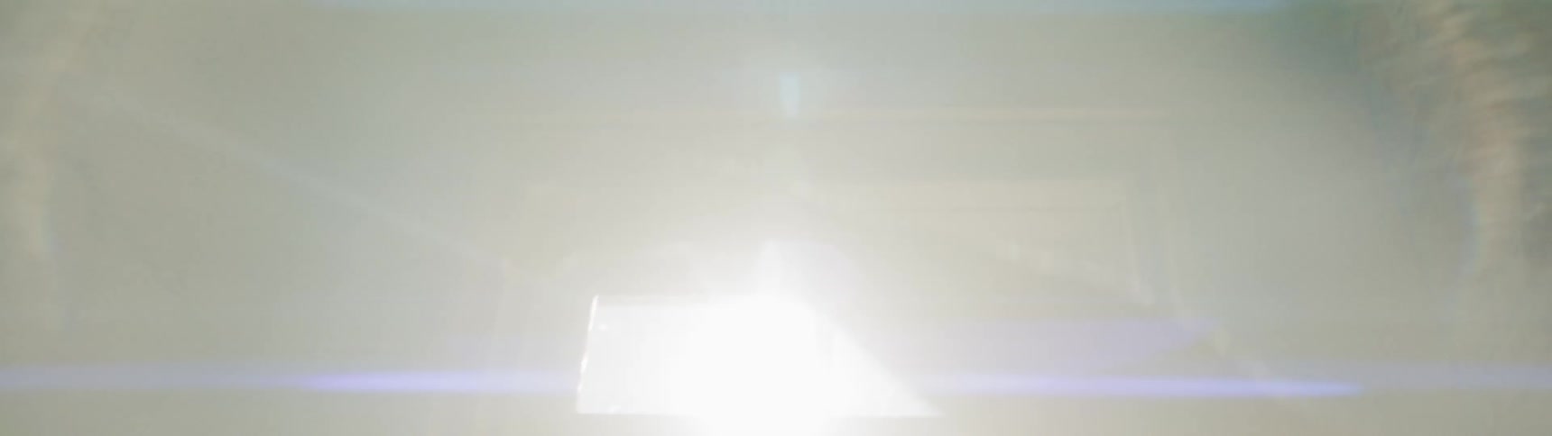 A person slowly raising their hand in the sunlight from a window