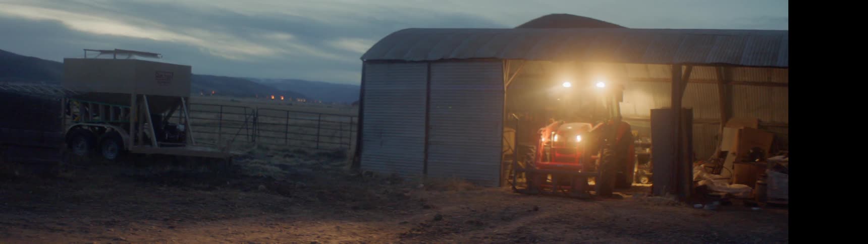 The tractor is parked in the barn