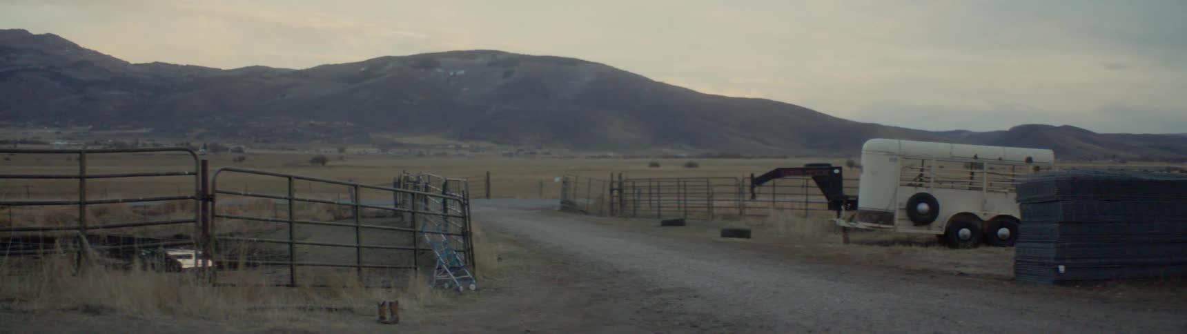 Gate to road country remains open with mountain on the horizon