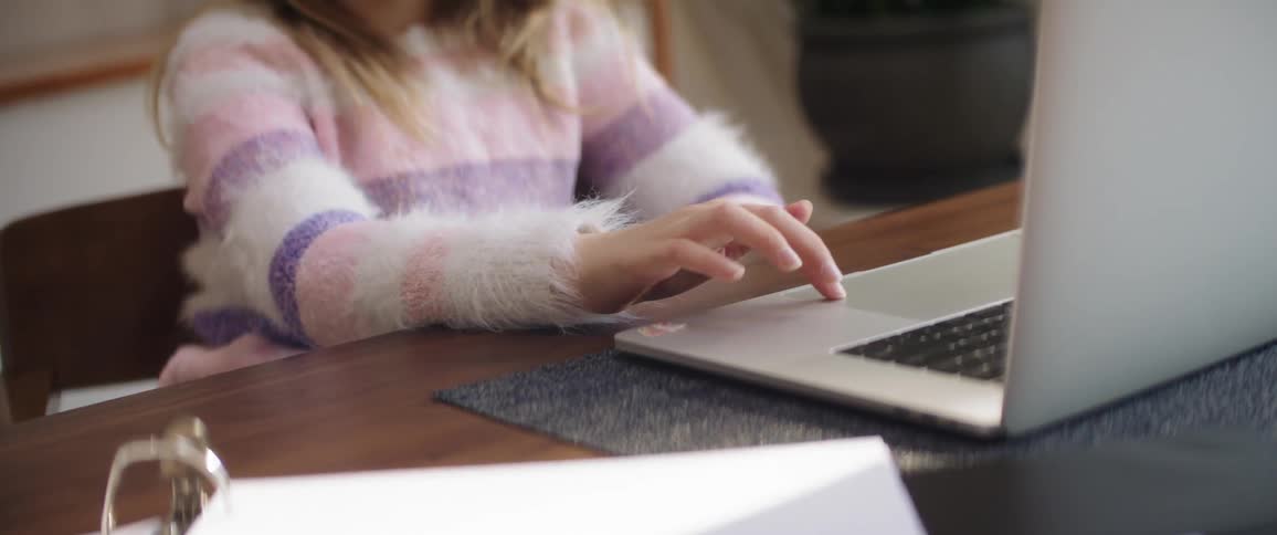 A child plays with the trackpad on a laptop