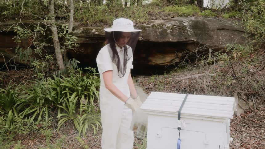 A woman is smoking a bee hive