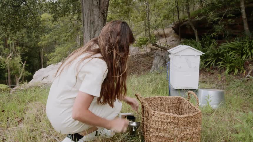 A woman looks through a basket for items