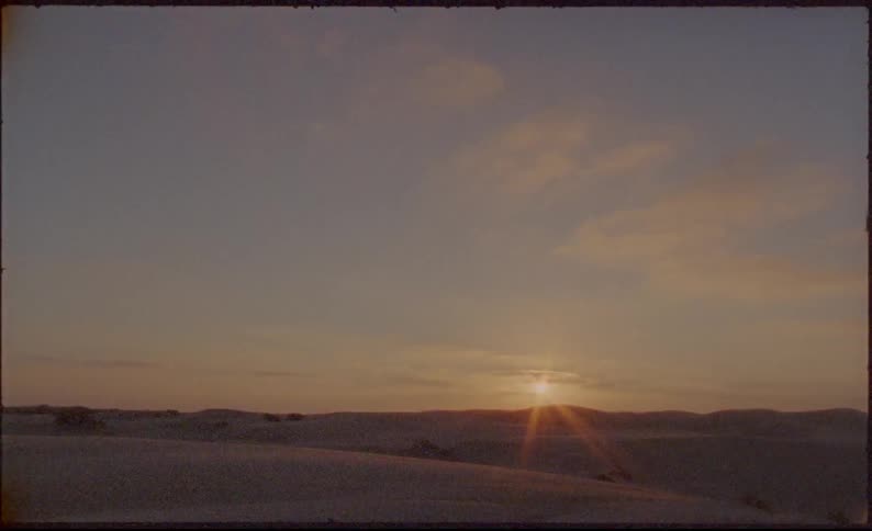 Vintage footage of desert dunes at sunset