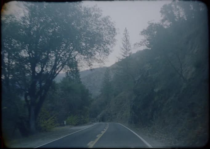 Point of view vintage footage of car running on a mountain road