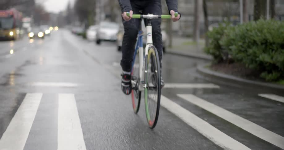 A man rides a bike down the street