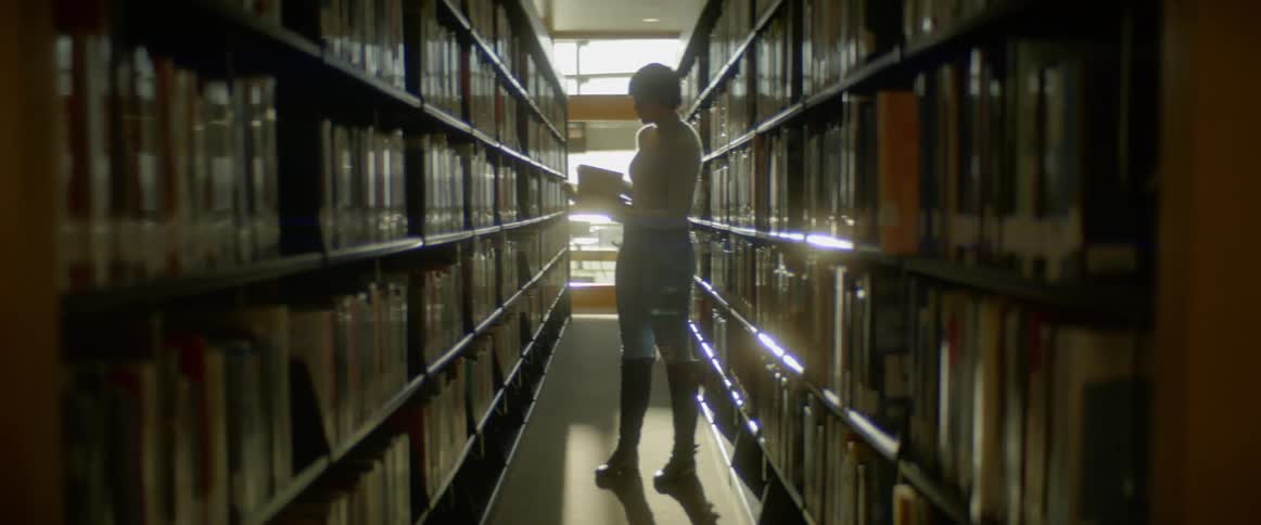 A woman looks at a book in a library