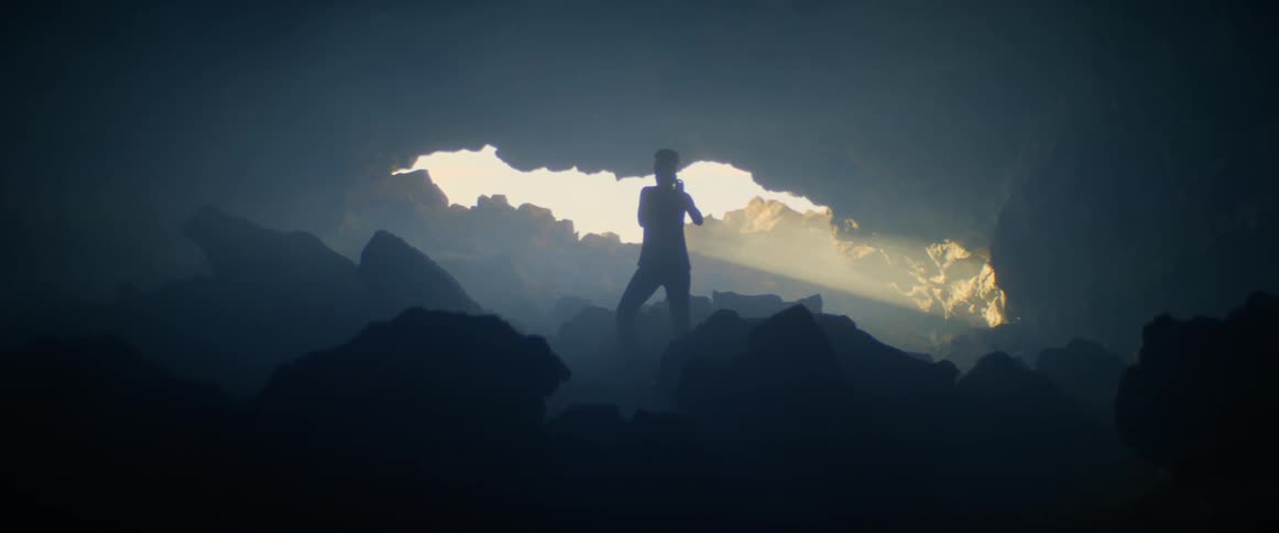 A person is hiking inside a cave