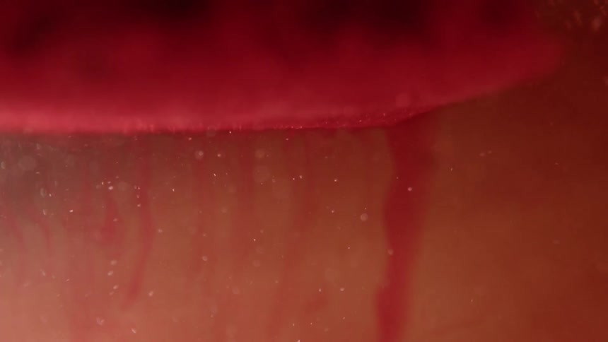 Abstract footage of red dye in liquid