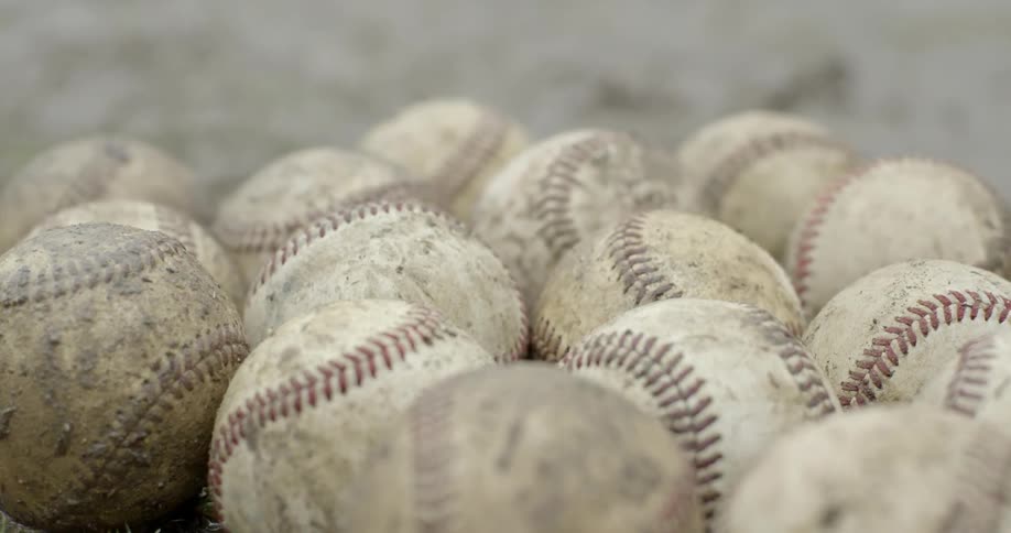 Scuffed and dirty baseballs on the ground